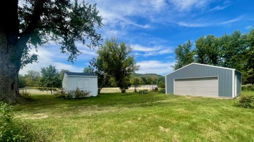 10' x 10' storage shed is to the left and generously sized 27' x 24' garage is to the right.