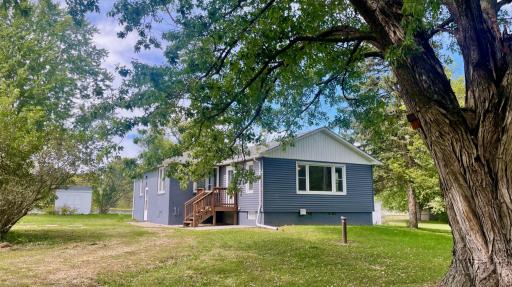 Enjoy total outdoor tranquility complete with mature greenery, lush lilacs, and your very own fire pit for cozy evenings.