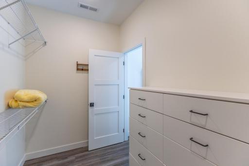Primary closet offers plenty of additional built-in storage.