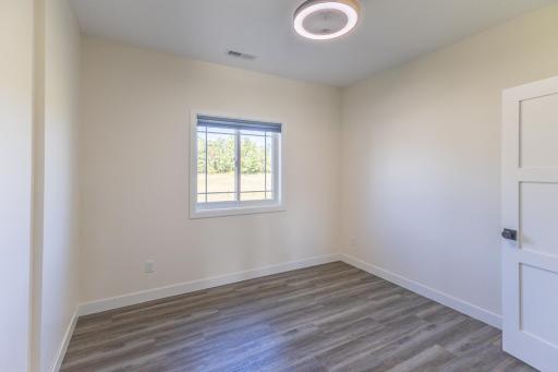Third bedroom with natural light and durable flooring.