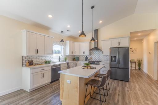 Large center island provides additional prep space, storage and casual seating.