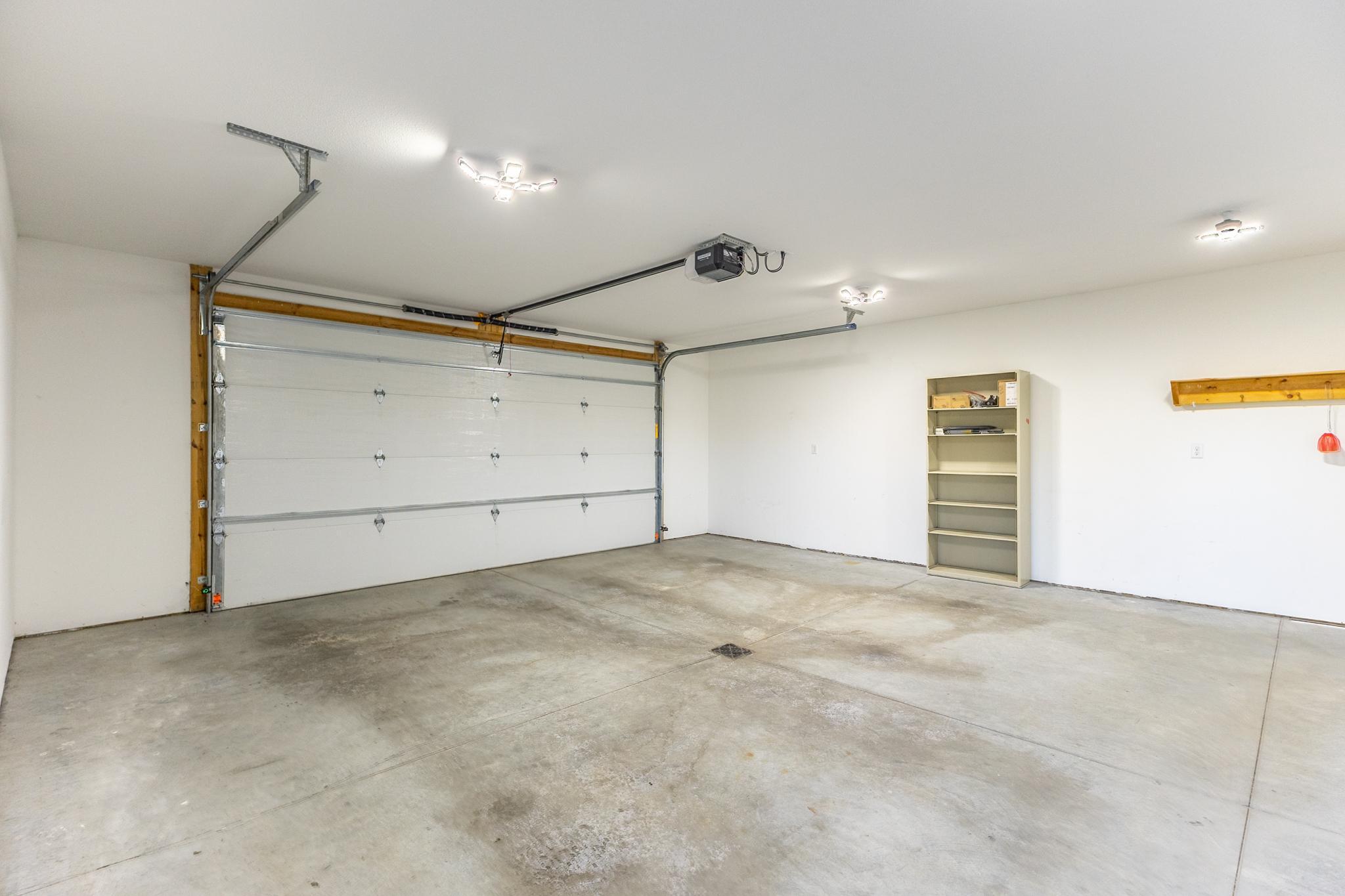 Heated and finished attached garage provides excellent parking, workspace and storage.
