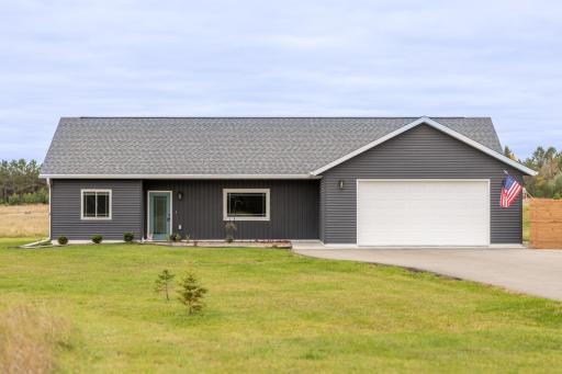Welcoming exterior with paved driveway and convenient one-level living.