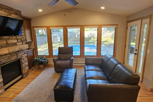 The main floor family room features hardwood floors, gas fireplace and overlooks a wonderful backyard with a refreshing pool.