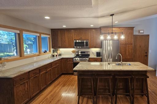This spacious kitchen features custom cabinets, granite countertops, stainless steel appliances and great natural light!