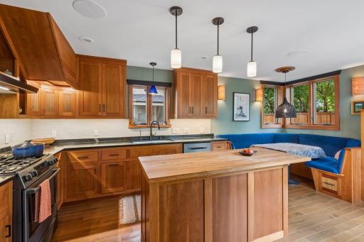 The kitchen is a place for gathering with family and friends. Cherry cabinetry, soapstone countertops on the perimeter and butcherblock on the island. Banquette seating and storage built-in.