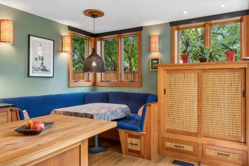 Cabinetry to the right of the banquette provides a drop zone for coats and shoes when entering the doors from the backyard to the kitchen.
