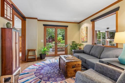 Living room has easy connection to the backyard, kitchen, and library