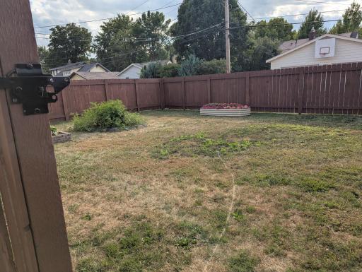 The back yard is completely fenced in - great for pets or the kiddos.