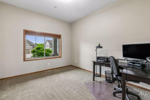 Office on the main level that is spacious and highlighted with natural lighting.