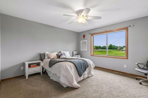Bedroom on the upper level that is spacious and has lovely natural lighting. There is a walk-in closet in this room as well! Plenty of space.