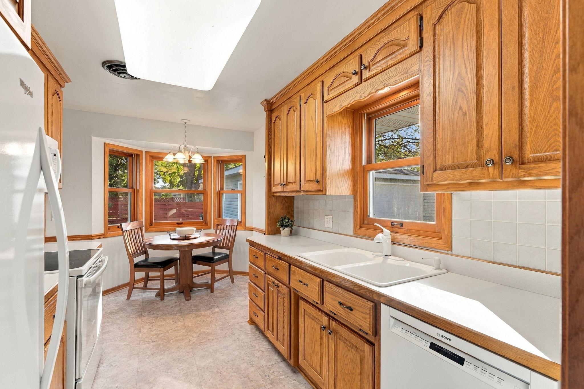 Solid oak kitchen cabinets and a bay window for an eat-in area.