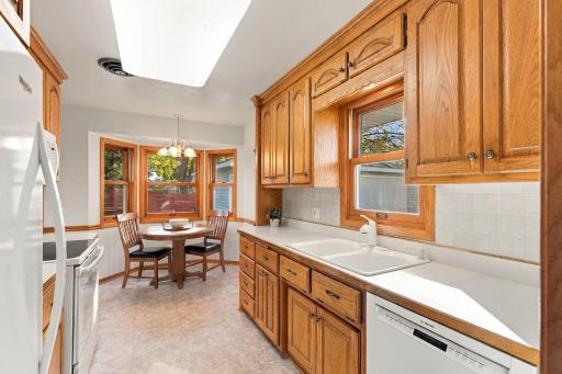 Solid oak kitchen cabinets and a bay window for an eat-in area.