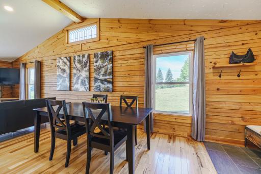 A charming window at the peak of the ceiling lets in additional light. The tile in the entry foyer is new. The eat-in table area has hickory hardwood flooring and a window that looks to the stable.