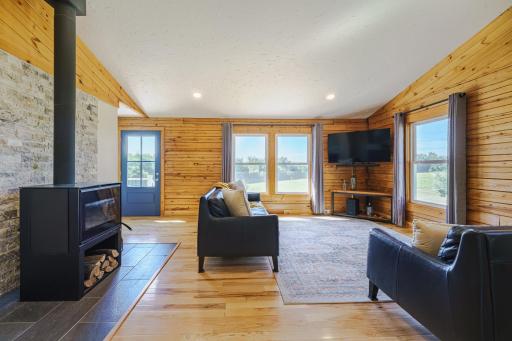 The woodstove by Osburn Inspire is backed by a new stacked stone accent wall and new tile flooring.