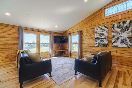 The family room has a freshly painted, vaulted ceiling with a new ceiling fan and the addition of recessed lighting.