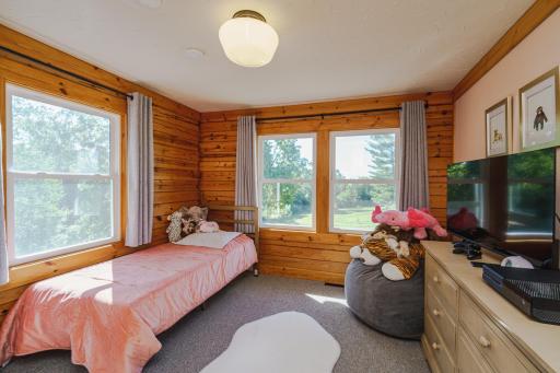 This is one of three bedrooms on the mail floor. It has crown molding, corner windows and sweeping views.