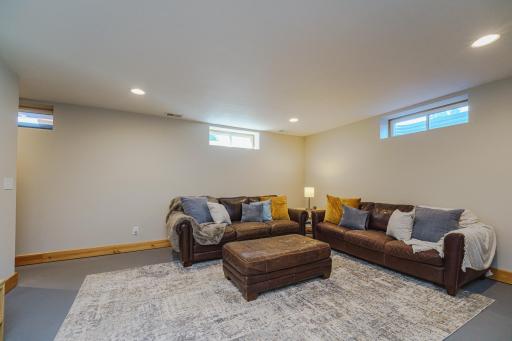 The lower level is bright, open, and functional for this acreage home. It includes a newly stained concrete floor and new custom millwork. The large family room space has a bright and clean floor and ceiling, with new windows.