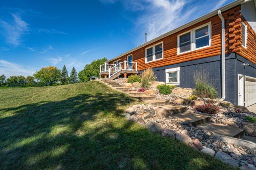 The boulder edging, river rock, perennial shrubs/plants around the home are all new.