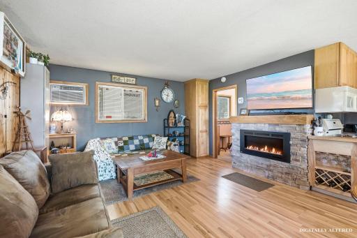 The living room offers a modern gas fireplace and room for entertaining