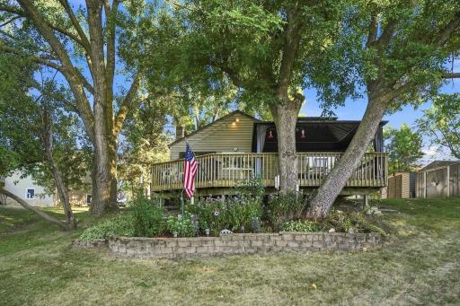 Beautiful landscaping sits below the expansive deck