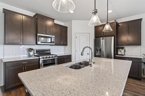 Quartz island and counter tops, double oven gas range and walk in pantry