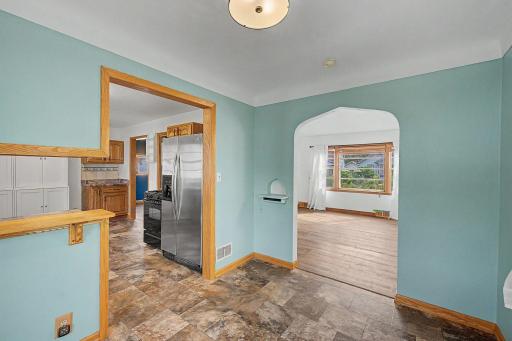 the dining room space connects the kitchen and the living space off of the entry