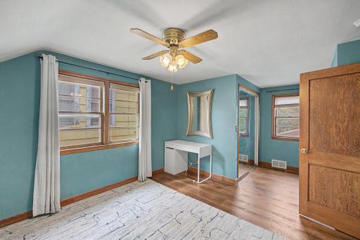 primary bedroom is larger than most in the area and features space for a desk and walk in closet
