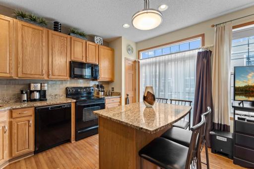 Beautiful kitchen with large kitchen island and walkout to deck.