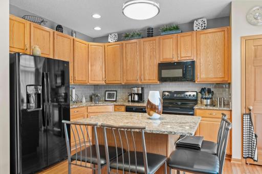 Kitchen with Granite countertops and tiled backsplash.