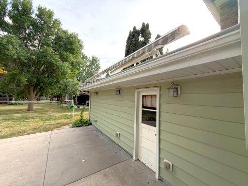 Awning mounted to roof of garage for sunny days