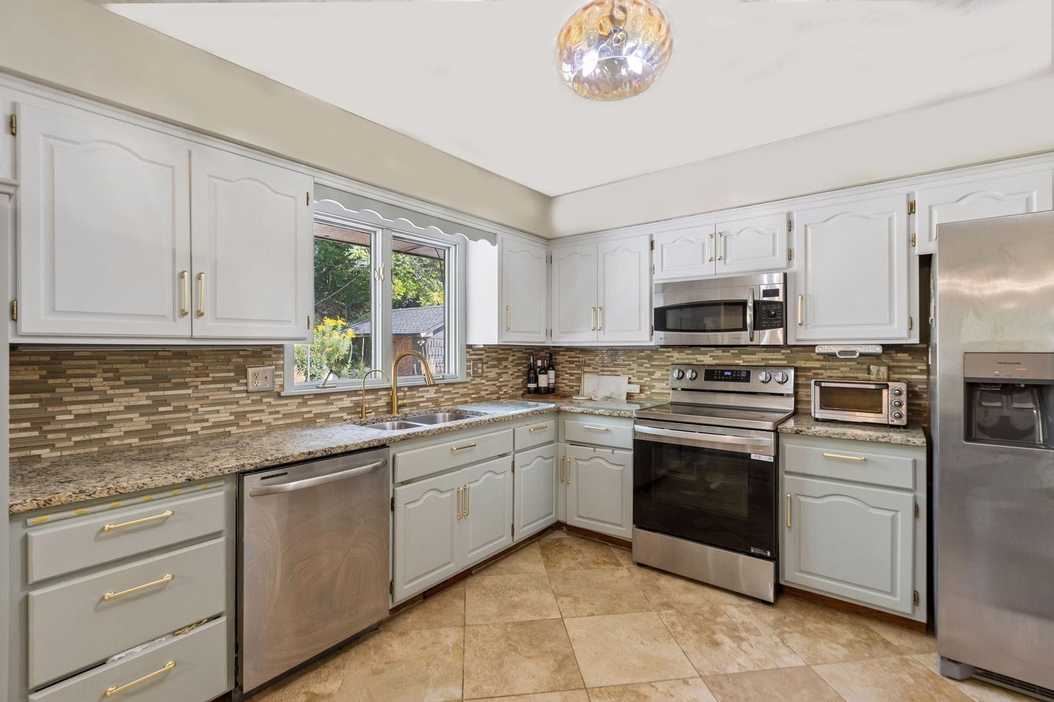 12. Updated kitchen featuring modern stainless steel appliances.jpg