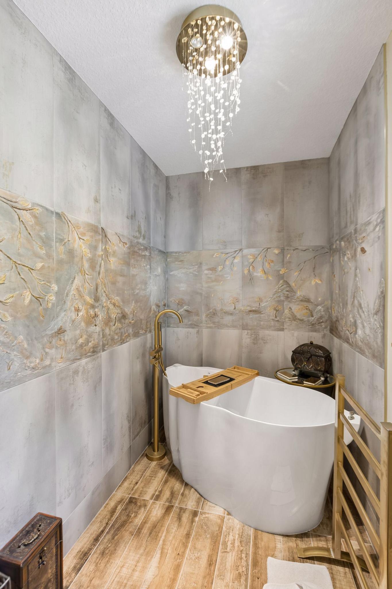 17. Spa-inspired primary bathroom sanctuary featuring a one-of-a-kind artistic backdrop and highlighted by raindrop light fixture.jpg