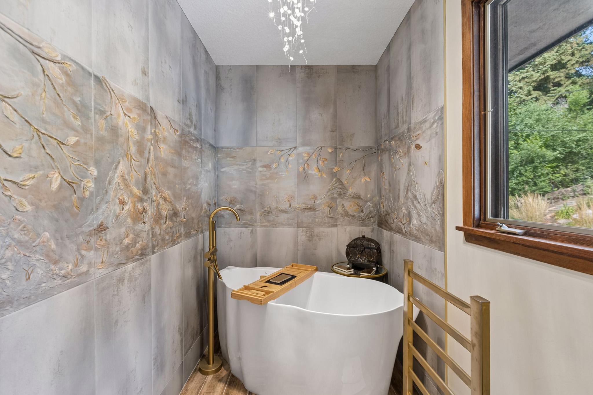 18. Primary suite retreat featuring scenic window views overlooking the peaceful backyard pond.jpg