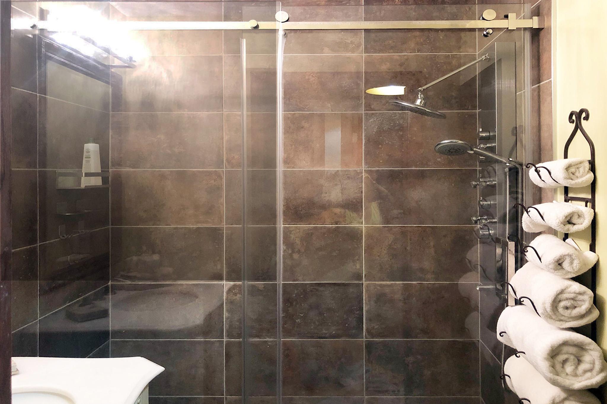23. Oversized shower featuring custom glass enclosure and multi-function tower.jpg