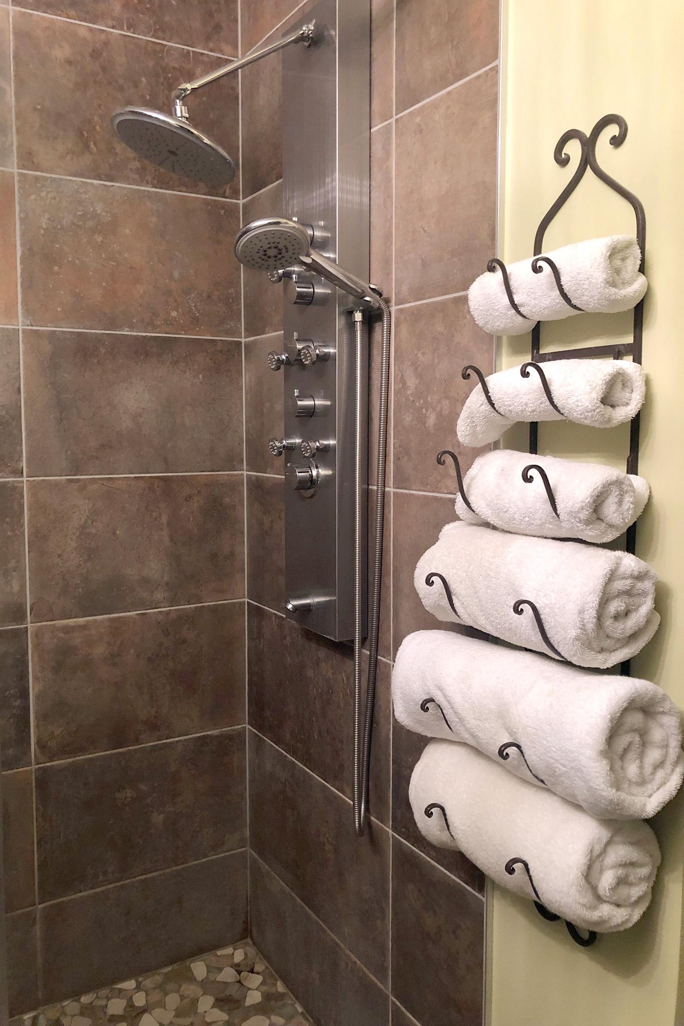 22. Sleek walk-in tile shower equipped with a multi-jet hydrotherapy shower tower.jpg