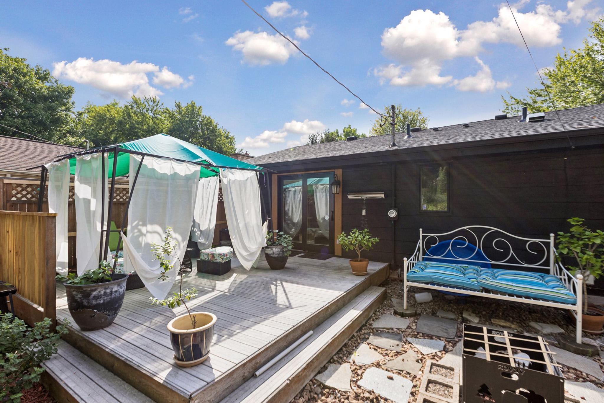 31. Spacious rear deck a private dreamy gazebo with sheer curtains.jpg