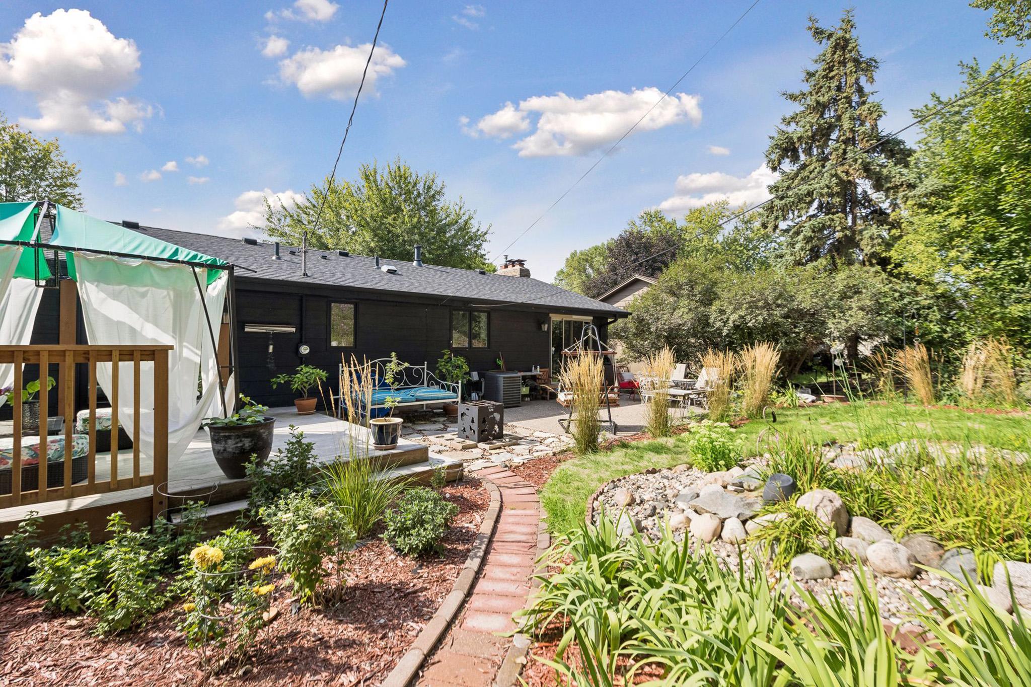 34. Outdoor lounge areas set against a backdrop of vibrant native gardens.jpg