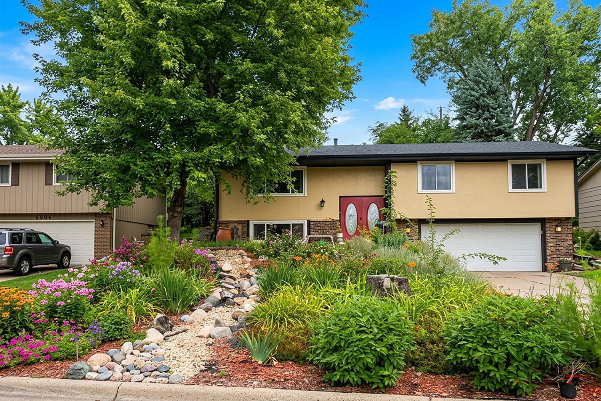 7. Cascading flower beds and rock river gutter drainage in the front.jpg
