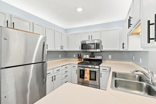 Stainless steel appliances, newer hardware and added lighting create a beautiful & functional kitchen space.