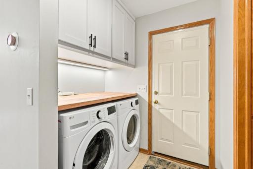 Well thought out laundry area recently redone with butchers block countertop and new LG washer + dryer.