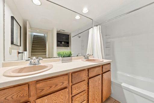 A spacious full bath with a double vanity and excellent storage.