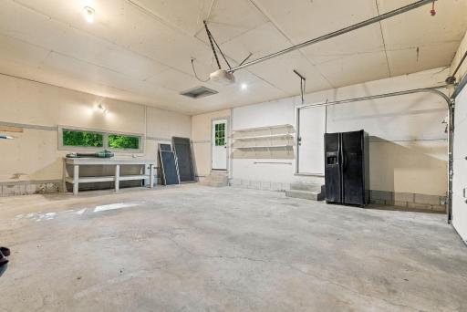 A spacious garage offers plenty of room for vehicles, storage, hobbies, and gear.