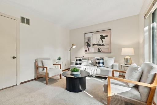 An upper-level sitting area offers flexible space for reading, work, or relaxation.