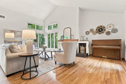 Vaulted ceilings, hardwood floors, and abundant natural light define the main living area.