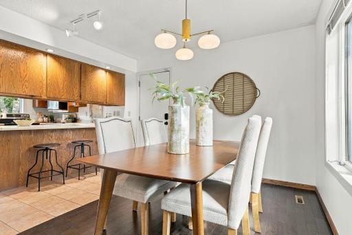 A bright dining area positioned conveniently between the kitchen and living spaces.