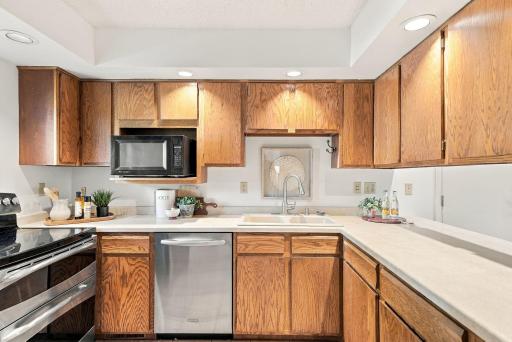 The kitchen offers generous cabinetry, workspace, and stainless steel appliances.