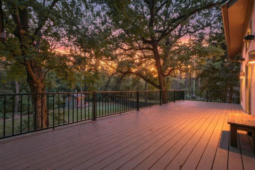 The expansive rear deck takes full advantage of the private wooded surroundings