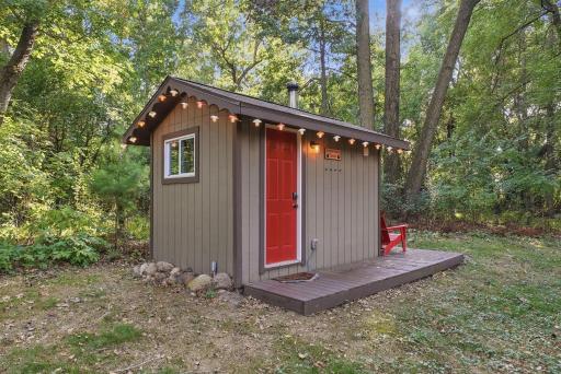 The backyard sauna offers a distinctive amenity surrounded by mature trees.