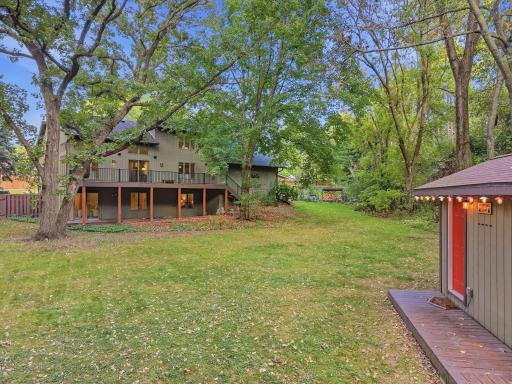The backyard setting offers privacy, mature trees, and room to enjoy the outdoors.